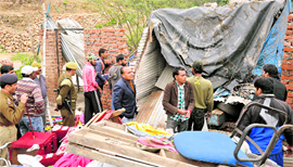 Northern Railway officials demolish an illegal structure built on the railway land in the Bahu Fort area of Jammu on Wednesday