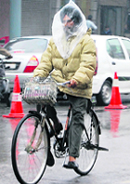 A cyclist caught in the rain in Amritsar