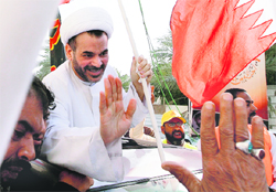 Shiite cleric Mohammed Habib Moqdad waves to his supporters after he was released by the Bahrain authorities in Manama on Wednesday
