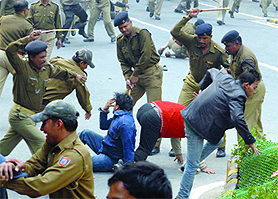 Policemen lathicharges BJP members during a protest against rising inflation.