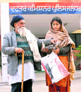 The parents of Asha Kaur outside the office of the Police Commissioner in Jalandhar on Thursday.