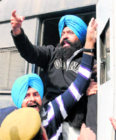 HIGH DRAMA: Paramjit Singh Bheora (top) curls his forefinger to simulate pulling a gun trigger to an activist of the Anti-Terrorist Front who was protesting against him even as Jagtar Singh Hawara (bottom) raises pro-Khalistan slogans. Both the terrorists, who have been convicted for assassinating Punjab Chief Minister Beant Singh, were brought to the District Courts from Tihar Jail for a hearing in the Burail jailbreak case in Chandigarh on Friday. While Bheora is facing life term, Hawara is on death row.