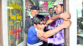 An alleged pickpocket being taken in custody by the police in Dehradun on Friday.