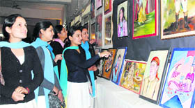 Students of MKP Girls College at a painting exhibition in Dehradun on Friday.