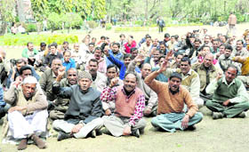 Class IV employees hold a protest in Dehradun on Friday.
