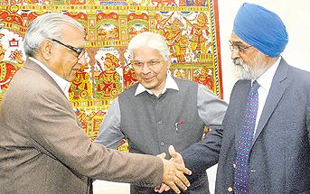 Chief Minister BS Hooda shakes hands with Deputy Chairman of the Planning Commission Montek Singh Ahluwalia in New Delhi on Friday.