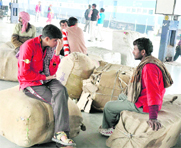 Porters await passengers at Jammu Tawi Railway Station 