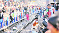 Passengers cross tracks at the Ludhiana railway station. 