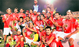 Members of Punjab men's hockey team jubilate after winning Gold during the 34th National Games in Ranchi on Friday. 