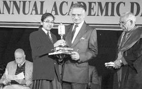Governor of Punjab Shivraj Patil gives away a prize to a student during the annual academic day celebrations at YPS in Patiala