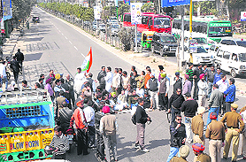 Congressmen block traffic in Jalandhar on Saturday. Tribune photo: Malkiat Singh