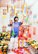 Tajendra Chauhan, a cricket fan, displays bats inside a makeshift temple and offers a prayer for Indias victory, in Ahmedabd on Saturday.