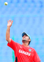 Mahendra Singh Dhoni catches a ball during a training session on the eve of the India-England match in Bangalore on Saturday.