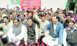 BJP workers protest at the Gandhi Park in Dehradun on Saturday.