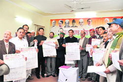 State Congress chief Yashpal Arya releases a poster highlighting the failures of the state BJP Government and achievements of the Centre in Dehradun on Sunday.