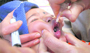 A health worker administers polio drops to a child at a dispensary in Shimla on Sunday.