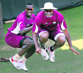 West Indies Kieron Pollard (R) and Andre Russell (L) jump during a practice session ahead of their World Cup match against Netherland in New Delhi on Sunday.  PTI