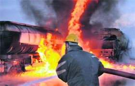A Pakistani firefighter battles flames emanating from NATO oil tankers after a blast on the outskirts of Peshawar on Saturday. Pro-Taliban militants in northwest and southwest Pakistan have destroyed hundreds of trucks and oil tankers carrying supplies and fuel to the US and NATO forces in Afghanistan over the past few years. 