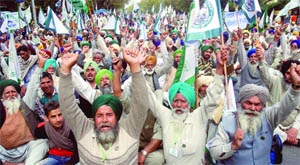 Activists shout slogans during  a rally under the banner of the Bharti Kisan Union (Ekta), Punjab, demanding remunerative prices for crops and waiving of agriculture loans at Parliament Street in New Delhi on Monday.