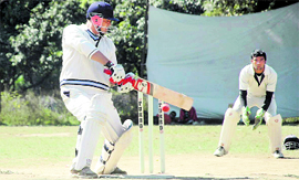 A batsman hits the ball in the Beehive Cricket Challengers Cup in Dehradun on Monday.