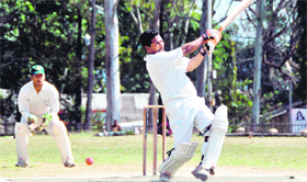 A batsman misses a shot in the Dehradun District Cricket League in Dehradun on Monday.