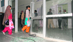 A door of SMGS Hospital, which was damaged by protesters in Jammu on Monday. 