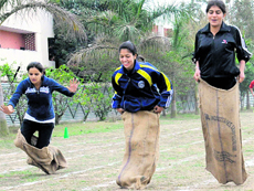 Students of Sri Guru Gobind Singh College of Pharmacy take part in a sack race in Sector 26 in Chandigarh on Tuesday