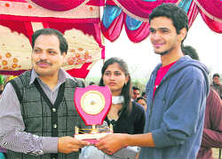 A winner receives an award at the sports meet.