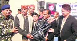 Trilok Kapoor, chairman, HP Wool Federation, gives away a medical kit to a shepherd at a camp.  