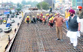 Improvement Trust Chairman Baljit Singh Neelamahal inspects the ongoing work at the BMC flyover in Jalandhar