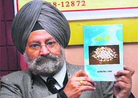 Karmajit Singh holds a copy of Sucche Moti, a religious poetry compilation by his father late Ranjit Singh Kharag, which was released in Jalandhar