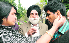 Vasil Khans sister shows the scars of alleged police torture on his body on Tuesday.The chairman of the Majha Ex-Servicemen Human Rights Front, Col GS Sandhu (retd), is in the centre