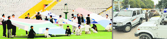 While students rehearse the ceremony before the start of the South Africa-Netherlands match inside the PCA Stadium, (right) chaos prevails outside due to haphazard parking of official vehicles in Mohali.