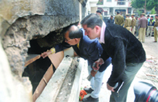 Forensic experts check the spot after two LPG cylinders burst in Amar Colony, Lajpat Nagar in New Delhi