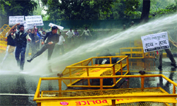 Protesting Delhi Youth Congress activists are water-cannoned outside the BJP office in New Delhi