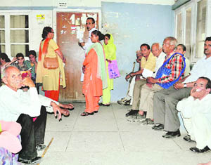 Patients wait for a doctor at the zonal hospital in Mandi.