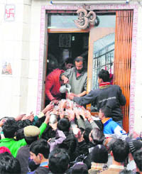 Devotees being offered milk as prasad at a Shiva temple on the occasion of Shivratri in Shimla on Wednesday.
