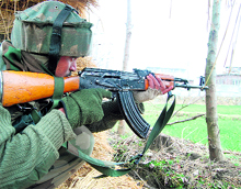 An Army jawan takes position during an encounter with militants in Pulwama