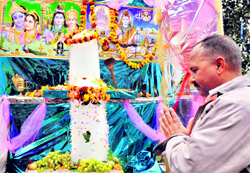 A devotee offers prayers at a temple in Jammu on Wednesday