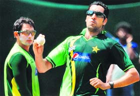 Pakistans Umar Gul (R) bowls as teammate Saeed Ajmal looks on during a training session at the R. Premadasa Stadium in Colombo