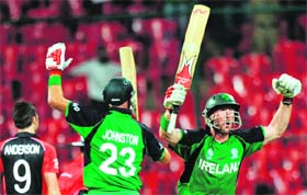 Irelands Trent Johnston (L) and John Mooney celebrate after scoring the winning runs against England in Bangalore on Wednesday. Ireland won by 3 wickets