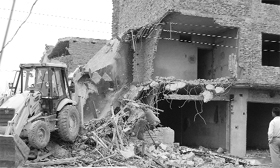 A team of the Municipal Corporation demolishes a three-storeyed building on the Ghel road in Ambala city on Thursday.