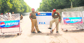 OUTPOST: Policemen find it hard to kill time as they guard a barricade meant to check a mad rush for the match.