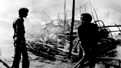 Shopkeepers of the Bajwara rehri market, Sector 22, douse flames after fire broke out in the market on May 23, 1989.