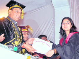 Former BJP national president Rajnath Singh presents a degree to a student at the convocation of DAV PG College in Dehradun on Thursday.