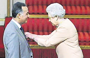 Queen Elizabeth II confers Membership of the Order of the British Empire on Dr Satya Vrat Sharma in London.