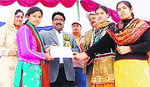 Deputy Commissioner Pankaj Aggarwal gives away certificates to the winning team at the annual day sports meet at Government Women College, Murthal.