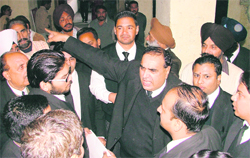 District Bar Association president Naval Kishore Chhibber (centre) gesticulates with his arm as he talks to agitating lawyers in Ludhiana on Thursday