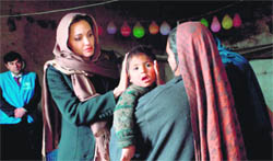UN Goodwill Ambassador Angelina Jolie meets Khanum Gul and her son Samir during a visit to their makeshift home in Kabul on Wednesday. 