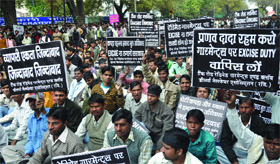 Members of the garment industry shout slogans against the union minister of finance, Pranab Mukherjee, for levying 10 per cent excise duty on garments, at Jantar Mantar in New Delhi on Friday.